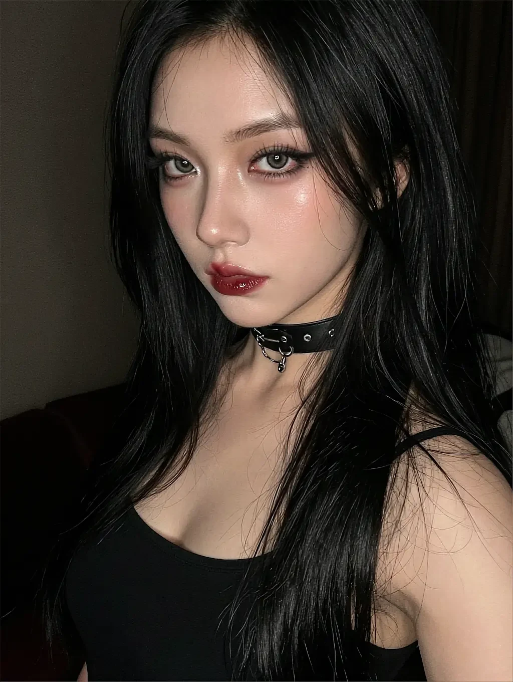 Fictional AI character on the WLW companion page, in a black top and studded choker in a dim bedroom